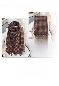 Detail of classic brown plaid scarf featuring thick cashmere texture and tassel edges