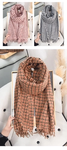 Detail of soft plaid scarves with fringe in pink, grey and caramel cashmere-like fabric