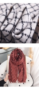 Macro detail of thick plaid scarf fabric texture and elegant fringe tassels in soft lighting