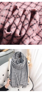 Macro detail of classic plaid cashmere-like scarf fabric texture and tassel fringe