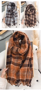 Detailed close-up of thick plaid scarves with classic fringe in multiple warm color options