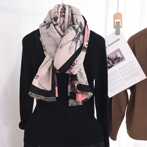 Elegant beige floral cashmere-feel scarf with fringes on black knit sweater
