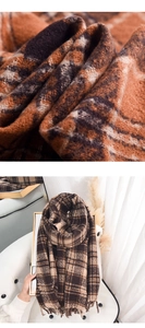 Close-up of thick plaid cashmere feel scarf with soft fringe and warm woven texture