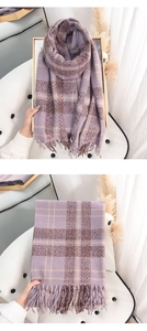 Detail of purple plaid tassel scarf with soft texture and classic checkered pattern