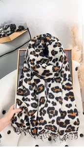 Detailed view of the leopard print scarf with soft tassels and warm cashmere feel