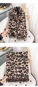Close-up of leopard print scarf with soft cashmere-like texture and delicate fringe trim