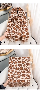 Close-up of leopard print scarf with soft cashmere-like texture and tassel fringe edges