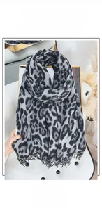 Detail shot of leopard print cashmere feel scarf with fringe tassels in grey and black
