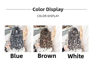 Three leopard print scarves in blue, brown, and white colors with fringe detailing