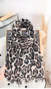 Close-up of leopard print cashmere feel scarf with delicate fringe edges and soft texture
