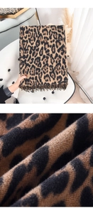 Close-up of leopard print cashmere feel scarf showing knit texture and fringe detail