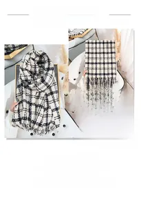 Macro detail of black and white checkered scarf featuring thick fabric and soft fringe edge