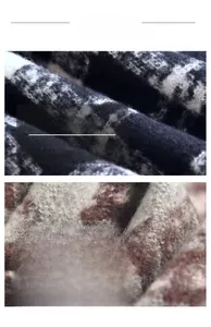 Detailed macro view of black and white plaid knit texture and soft beige plush scarf fabric