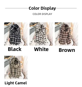 Close-up of thick plaid scarves in black, white, brown and camel with soft fringe