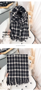 Detail of black and white plaid imitation cashmere scarf with fine tassel edges