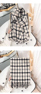 Detail of classic black and white plaid knit scarf with soft fringe and textured fabric