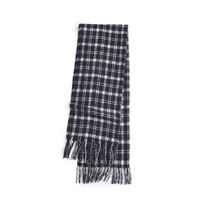 Classic black and white plaid knit scarf with fringe tassel trim for winter warmth