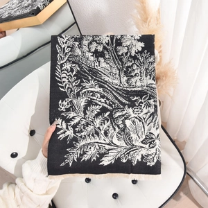 Elegant Toile de Jouy floral cashmere-like scarf with fringe on a white chair