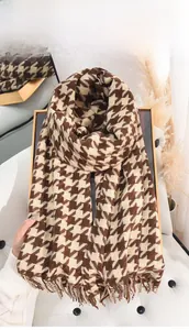 Close-up of thick houndstooth knit scarf in dark coffee and beige with tassel fringe