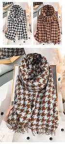 Close-up of thick knit houndstooth scarf with tassels in elegant winter setting