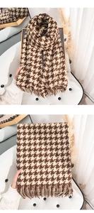 Detailed view of the brown houndstooth pattern scarf with soft fringe edges and texture