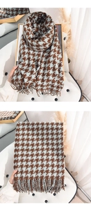Detail of houndstooth scarf with tassels in brown and light blue cashmere-like fabric