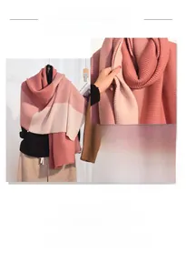 Detail of color-blocked orange and pink cashmere-like scarf with ribbed knit texture