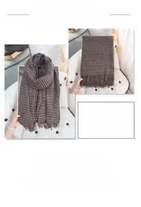 Close-up of thick brown plaid scarf fabric with fringe detail on a leather chair