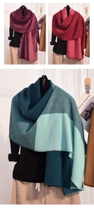 Detail of color-block knit cashmere shawl showing chunky vertical ribbed texture and drape