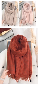 Detail of soft cashmere-like scarf showing classic houndstooth pattern and fringe trim