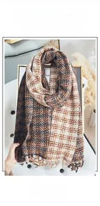Close-up of double-sided checkered scarf showing soft cashmere-like texture and fringe trim