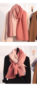 Detailed close-up of pink pleated cashmere-like scarf with bicolor stitching and fine texture