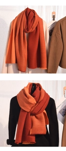 Detailed view of the rib-knit texture on the orange and brick red color-block scarf