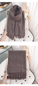 Detailed view of dark coffee and white houndstooth cashmere scarf with fringe edges