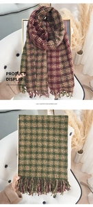 Detail of plaid imitation cashmere scarf with tassels in green and wine red colors