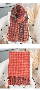 Detail showing high-quality red-brown plaid scarf fabric texture and fringe tassels