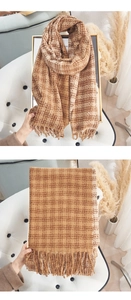 Close-up of brown plaid scarf with fringe detail and soft cashmere-like texture