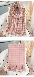 Close-up of soft cashmere-like scarf featuring dual-color plaid patterns and long tassels