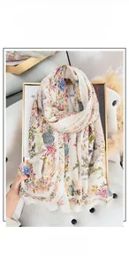 Detail of floral printed scarf in pastoral style with pink and blue flowers pattern