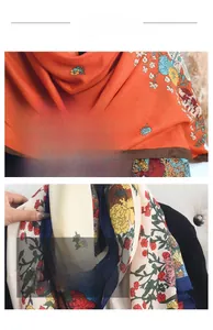 Detail view of floral print scarves featuring orange and cream patterns with fine stitching