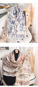 Detail of artistic floral print scarves with vintage birds on lightweight silky fabric