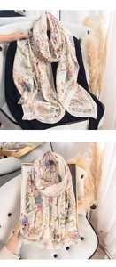Detail of floral print scarf with light beige chiffon texture and delicate hem finishing