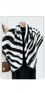 Detail of zebra pattern square scarf with cotton-linen feel shown on a wooden hanger