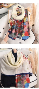 Close-up of floral print scarf showing lightweight linen texture and vibrant retro patterns