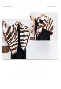 Detail of silk zebra print scarf draped on a wooden hanger with smooth texture