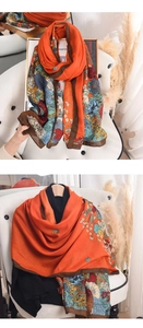Close-up of Bohemian floral print scarf featuring vibrant orange and deep brown borders