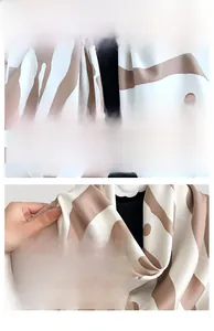 Detail shot of zebra stripe silk scarf showing satin texture and fine edge stitching