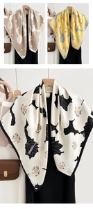 Détail d'un grand foulard carré en soie avec imprimés floraux vintage et texture premium
