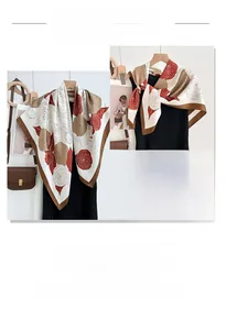 Close-up of elegant floral print silk scarf with deep red and tan rose patterns