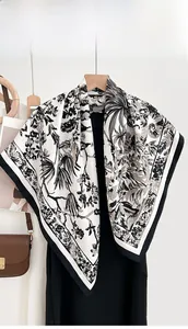 Detail of elegant square silk scarf with vintage botanical palm leaf print on ivory base